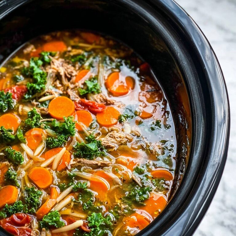 Slow Cooker Chicken, White Bean, and Kale Soup with Parmesan Shavings Recipe